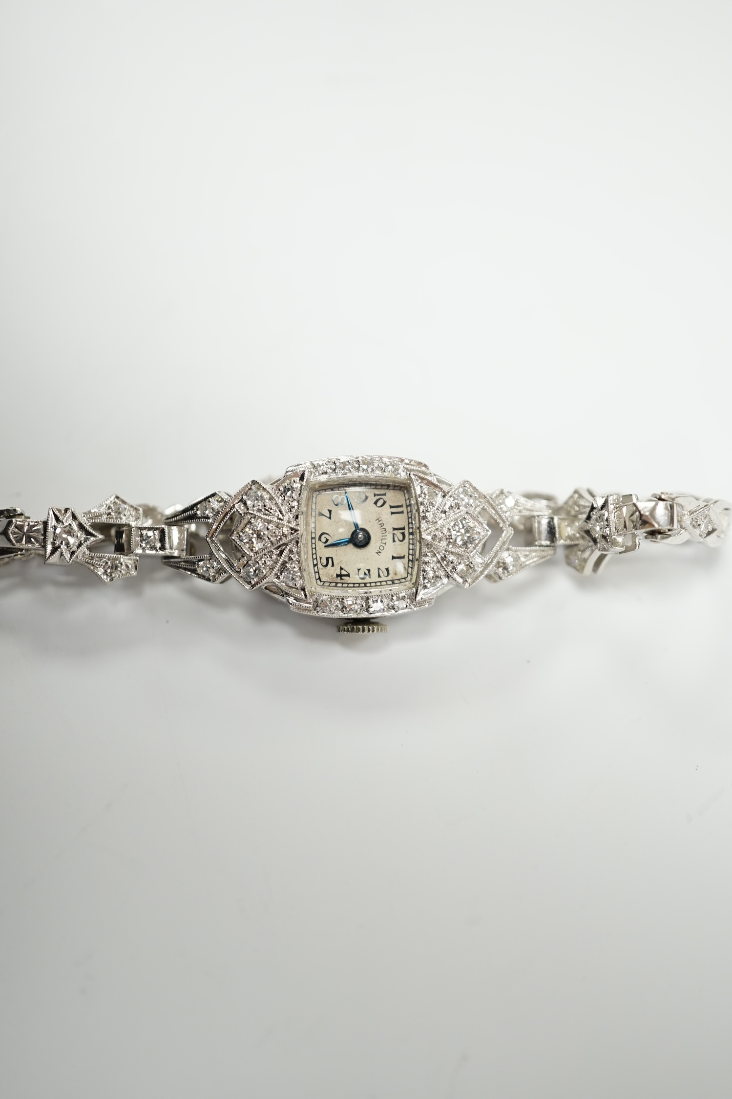 A lady's white metal (stamped irid and platinum) and diamond cluster set manual wind Hamilton cocktail watch, approx. 15cm, gross weight 24.6 grams.